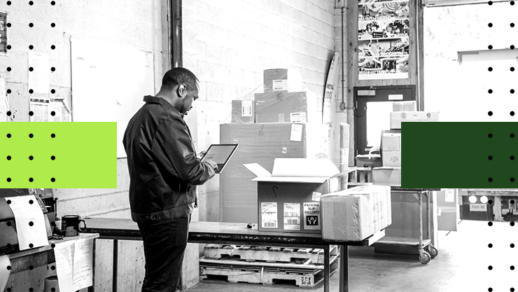 A man using a tablet in a warehouse