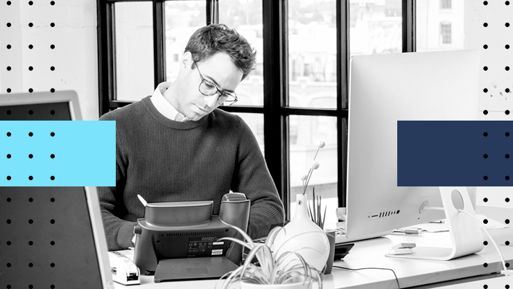 A stylized image of a man working at a desk