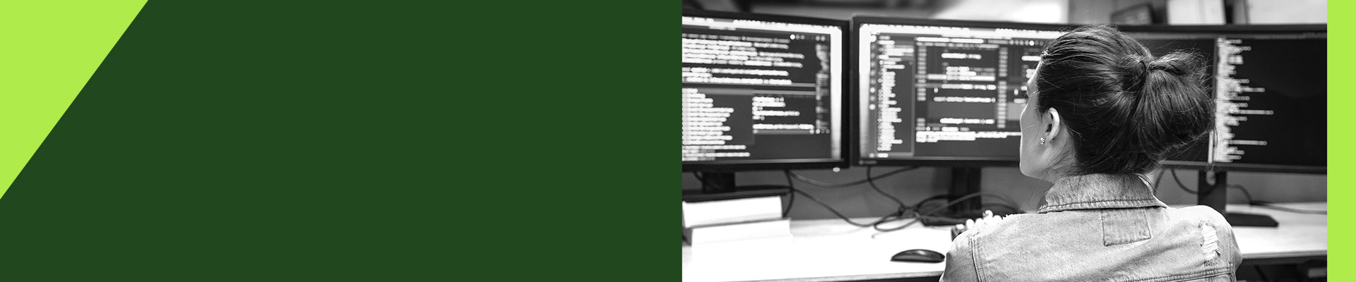 A woman sitting at a desk with three computer monitors displaying code